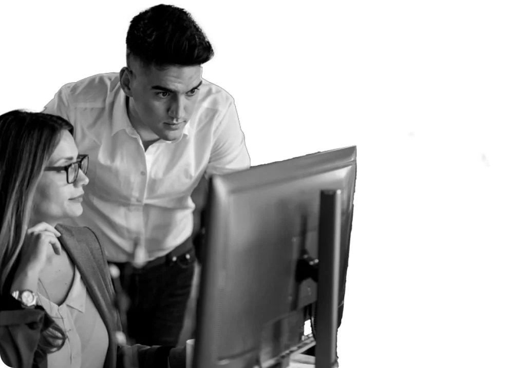 two-young-business-colleagues-using-desktop-pc-reading-email-while-working-together